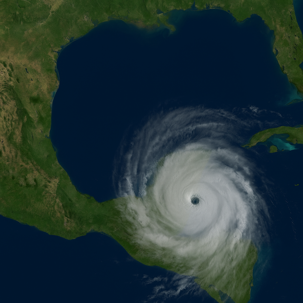 Satellite image of a powerful hurricane forming over the Gulf of Mexico, with a clearly defined eye and spiral cloud bands approaching the southern United States, including the Louisiana coast.